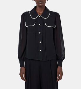 بلوزة بأكمام شفافة مطرزة بلؤلؤ