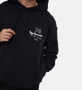 هودي فضفاض مضلع بطبعة شعار