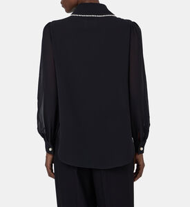 بلوزة بأكمام شفافة مطرزة بلؤلؤ