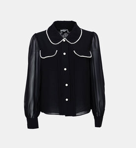 بلوزة بأكمام شفافة مطرزة بلؤلؤ