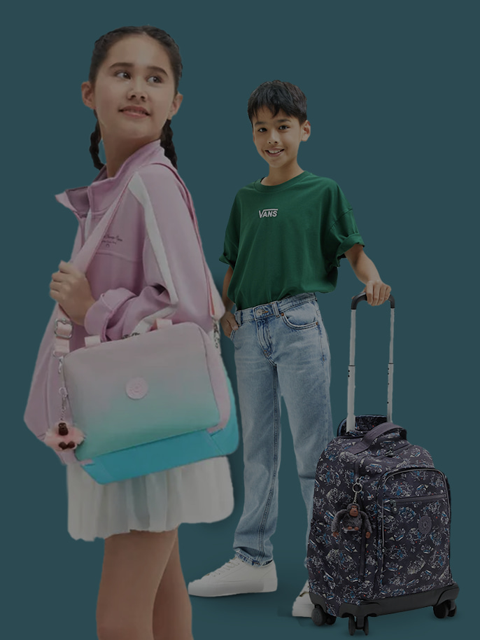 Image of kids with Kipling bags on green background